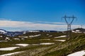 Power line voltage tower in mountains against blue sky Royalty Free Stock Photo