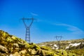 Power line voltage tower in mountains against blue sky Royalty Free Stock Photo