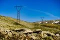 Power line voltage tower in mountains against blue sky Royalty Free Stock Photo