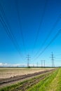 Power line wires run over field Royalty Free Stock Photo