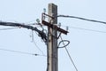 Power line on a wooden post against the blue sky Royalty Free Stock Photo