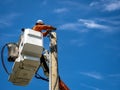 Power lineman at work in an aerial bucket connecting a new house service on a summers day Royalty Free Stock Photo