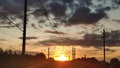 Power lines against a cloudy sunset Royalty Free Stock Photo