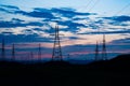 Power lines against dark sunset sky Royalty Free Stock Photo