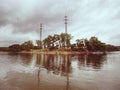 Power lines built on island in water. Technological progress Royalty Free Stock Photo