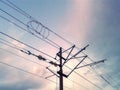 Power lines in the city. Electric cables attached to a street power pole under blue sky. Royalty Free Stock Photo