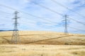 Power lines and pylons crossing arid land