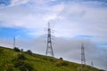 Power lines in the field. Summer landscape with high tension lines in nature on the hill. High voltage, power Royalty Free Stock Photo