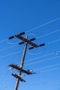 Power lines and insulators against a clear blue sky Royalty Free Stock Photo