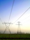 Power lines in the morning fog Royalty Free Stock Photo