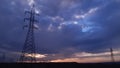 Power lines and poles at sunset Royalty Free Stock Photo