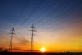 Power lines at sunset, sun rays. High voltage tower against the sky Royalty Free Stock Photo