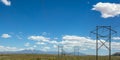 Power lines with view of mountain under blue sky Royalty Free Stock Photo