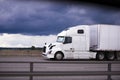 Power modern white rig semi truck trailer side view cab Royalty Free Stock Photo