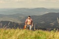 Power of Music. sexy man with guitar in checkered shirt. hipster fashion. western camping and hiking. happy and free