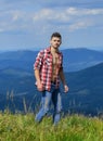 Power of nature. Man unbuttoned shirt stand top mountain landscape background. Muscular tourist walk mountain hill