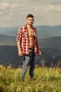 Power of nature. Man unbuttoned shirt stand top mountain landscape background. Muscular tourist walk mountain hill