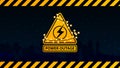 Power outage, yellow warning logo wrapped with a garland on the background of the city without electricity