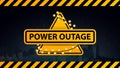 Power outage, yellow warning logo wrapped with a garland on the background of the city without electricity