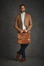 The power outfit. Studio shot of a handsome young man posing against a gray background. Royalty Free Stock Photo