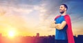 Man in red superhero cape over city background Royalty Free Stock Photo