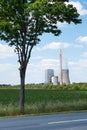 Power plant behind a tree
