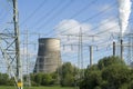 Power plant and electricity pylons between trees Royalty Free Stock Photo