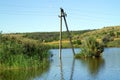 The power pole is located in the water of the lake. Royalty Free Stock Photo