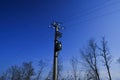 Power pole mounted mains. High voltage three phase transformer across blue sky, the transmission lines