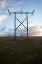 Power pole with sunset in Iceland. Light and shadow over the lan Royalty Free Stock Photo