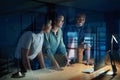 The power of productivity times three. a group of young businesspeople using a computer together during a late night at Royalty Free Stock Photo