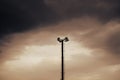 Power and public lighting tower on vivid dramatic clouds background in dusk, copy space Royalty Free Stock Photo