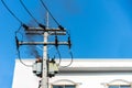 Power pylon overload or electric short circuit at transformer on poles and fire or flame with smoke on blue sky Royalty Free Stock Photo