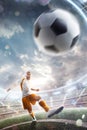 Power soccer kick. A soccer player kicks the ball in stadium. Professional soccer player in action. Wide angle. Vertical Royalty Free Stock Photo