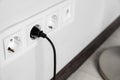Power socket and plug on wall indoors, closeup. Space for text Royalty Free Stock Photo