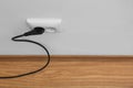 Power socket and plug on wall indoors, space for text Royalty Free Stock Photo