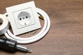 Power socket, screwdriver, cable and insulating tape on wooden table. Space for text Royalty Free Stock Photo