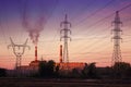 Power station with smoking chimney among electric wires Royalty Free Stock Photo