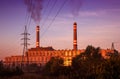 Power station with smoking chimney among electric wires Royalty Free Stock Photo