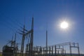 Power station and sun on a blue sky background.Energy equipment.High tension power. electricity line. Power lines on Royalty Free Stock Photo