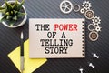 THE POWER OF STORYTELLING - text on notepad on wooden desk