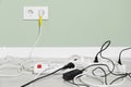 Power strips with different electrical plugs on floor indoors, space for text Royalty Free Stock Photo