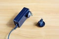 Power supply adapter lies on wooden surface with connect US socket, variations plug for EU Royalty Free Stock Photo