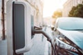 Power supply for electric car charging. Electric car charging station on urban europe street with blurred nature Royalty Free Stock Photo