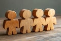 The Power of Teamwork Four Wooden Figures Standing Together, Symbolizing Unity in Task-Oriented Collaboration, Shared Goals, and
