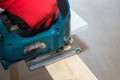 Power tool for home repair. Image of electric fretsaw in action