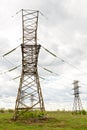 Power tower in a field on a cloudy day Royalty Free Stock Photo