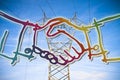 Power tower and transmission lines on blue background with hands Royalty Free Stock Photo