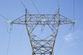 Power tower and transmission lines on blue background Royalty Free Stock Photo