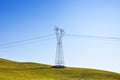 Power tower and transmission lines isolated in a green hill Royalty Free Stock Photo